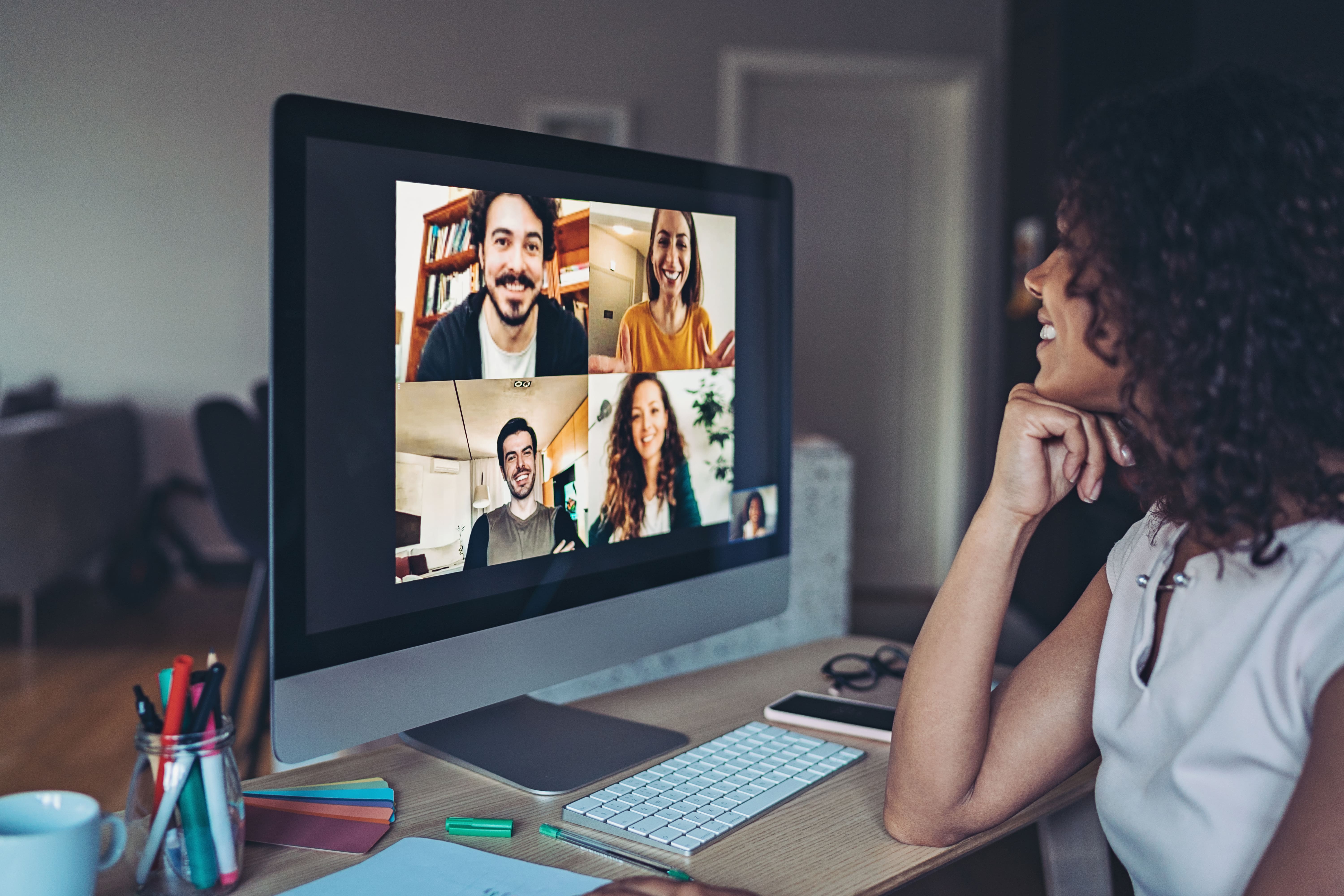 A woman doing a video conference at her computer