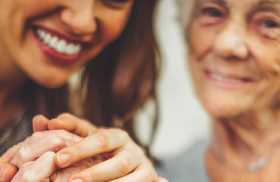 Two women holding hands and smiling