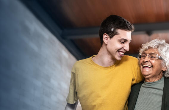 World cancer day promotion. Three people hugging and smiling at each other.