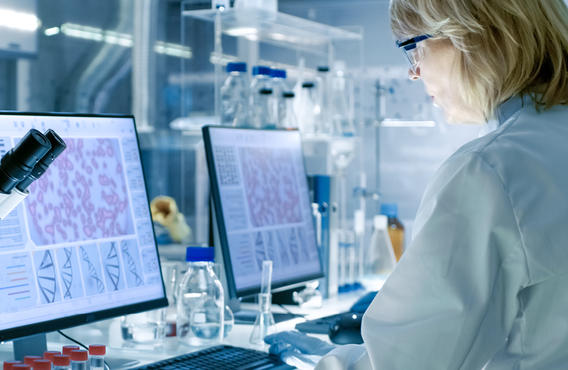 Femme dans un laboratoire, analysant des données sur son ordinateur