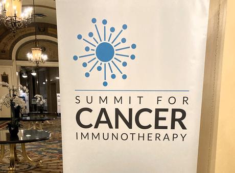 "Summit for cancer immunotherapy #Summit4CI" sign