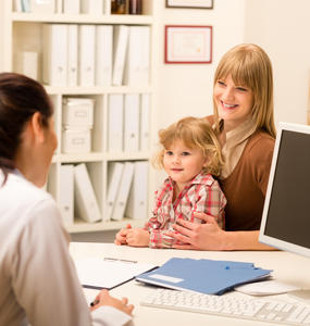 Pediatric doctor with child and mother