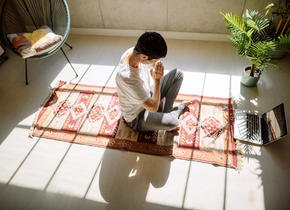 Person meditating in bright room